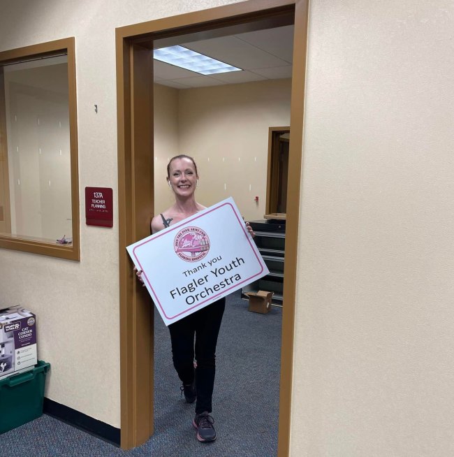 The author with a particularly evocative sign on Friday.  (© FlaglerLive)